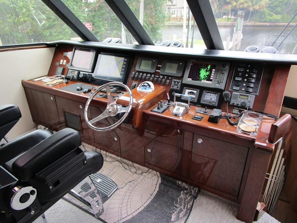The helm station features advanced navigation equipment and luxurious wood finishes. aboard SHORE GIRL Yacht for Sale