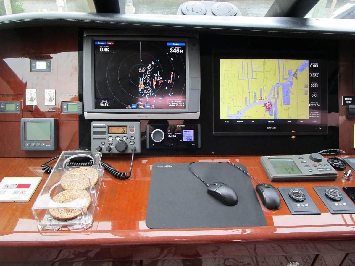 The helm station features advanced navigation and communication equipment for precise control. aboard SHORE GIRL Yacht for Sale