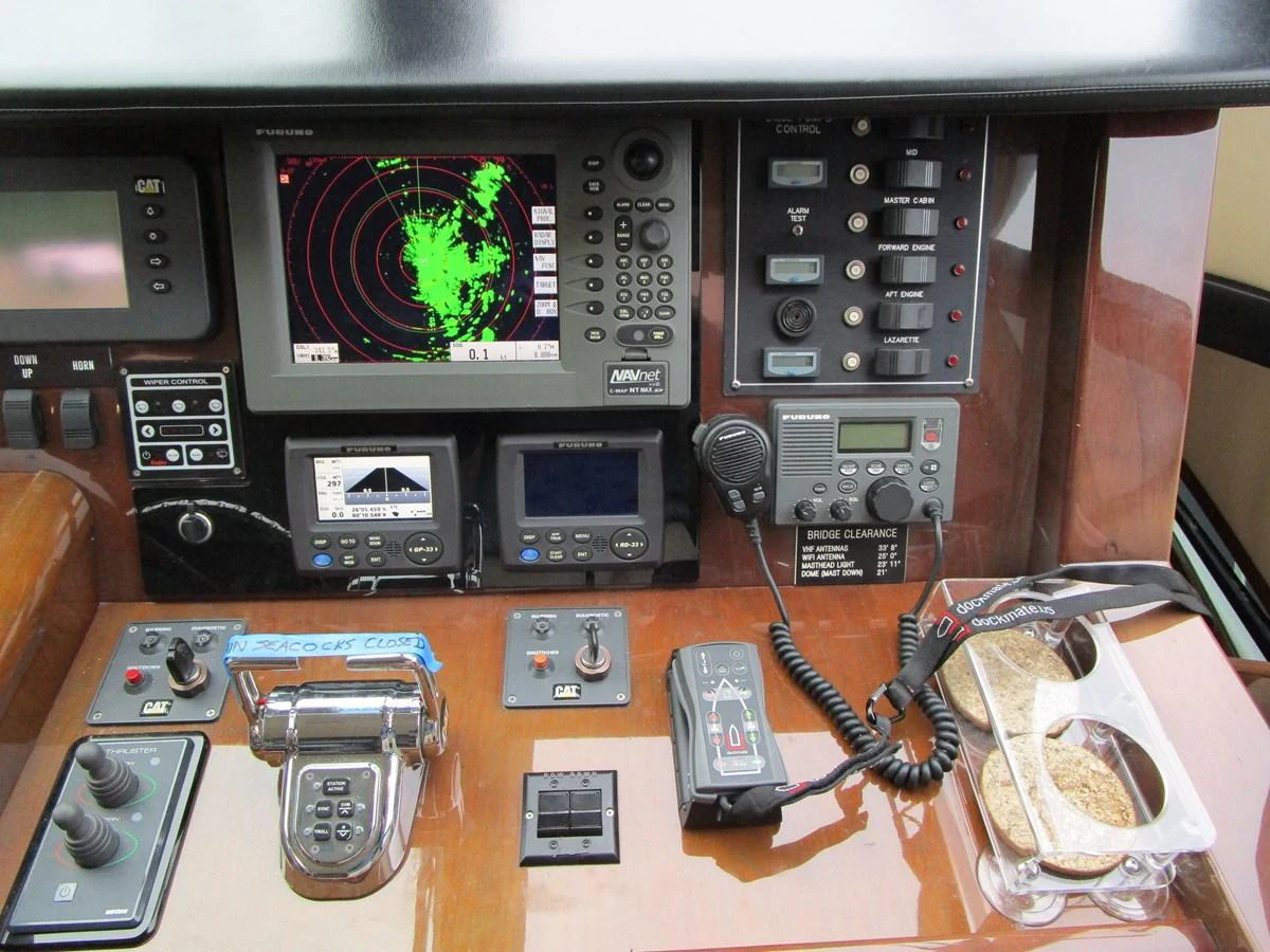 The helm station features advanced navigation and communication equipment for precise control. aboard SHORE GIRL Yacht for Sale