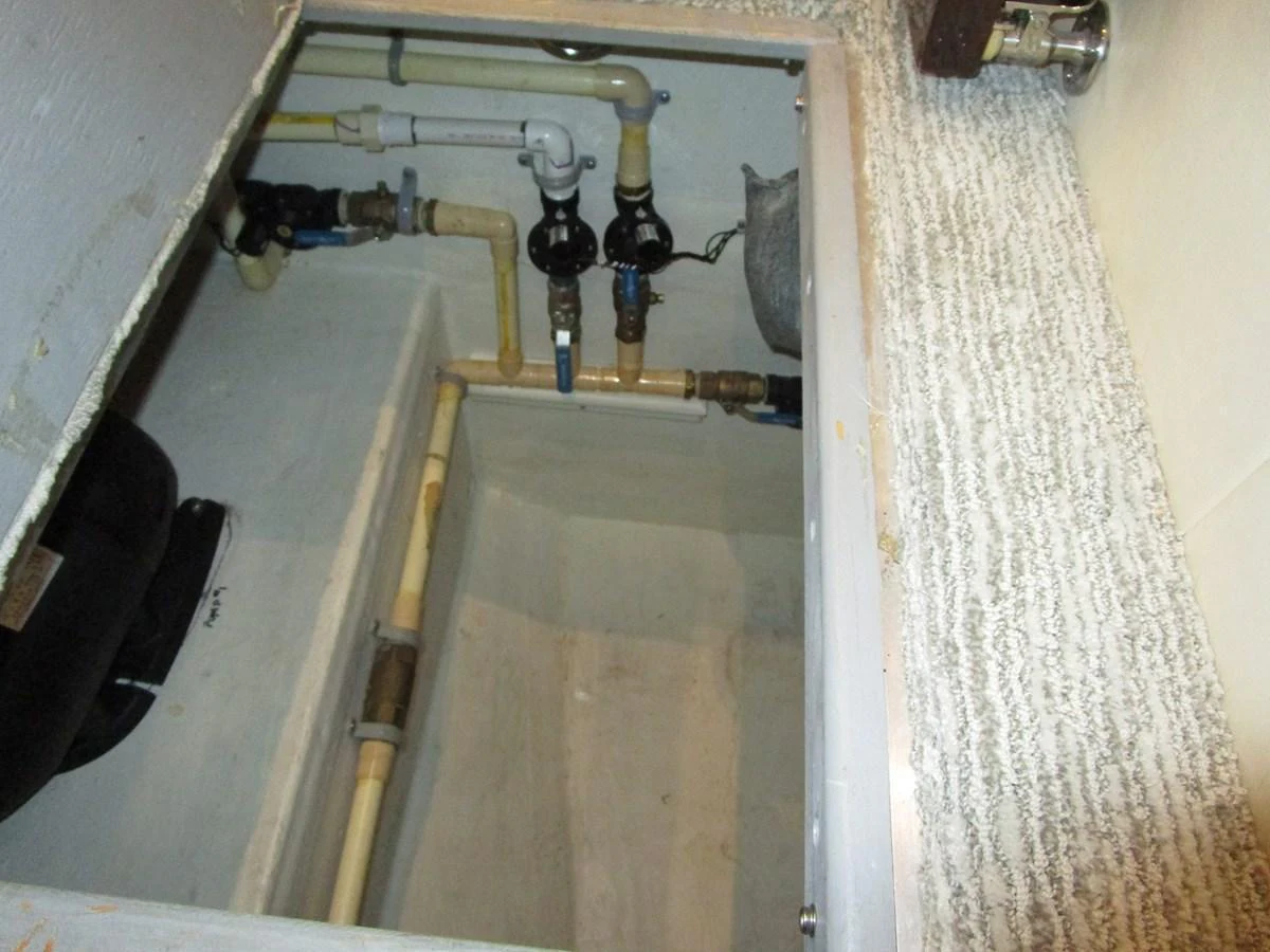 A close-up view of the yacht's plumbing system in a maintenance compartment. aboard SHORE GIRL Yacht for Sale