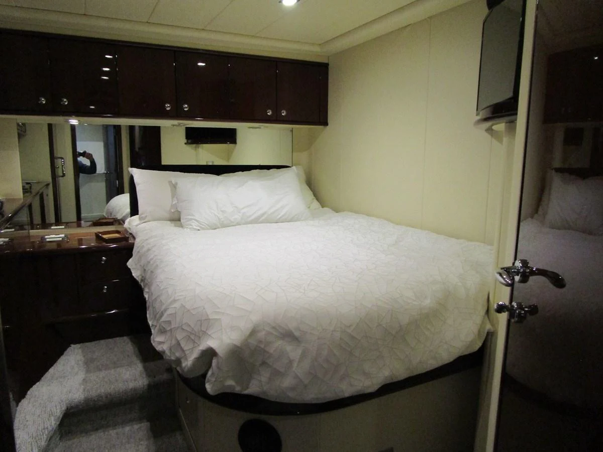 A cozy stateroom featuring a comfortable bed with plush bedding and ample storage space. aboard SHORE GIRL Yacht for Sale