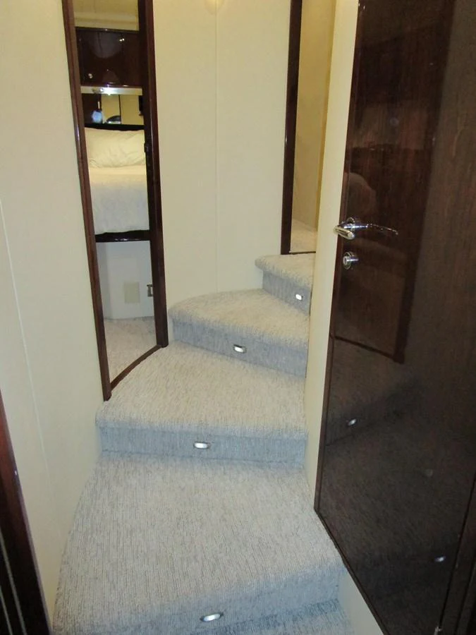 A cozy interior staircase with carpeted steps leading to the lower deck. aboard SHORE GIRL Yacht for Sale