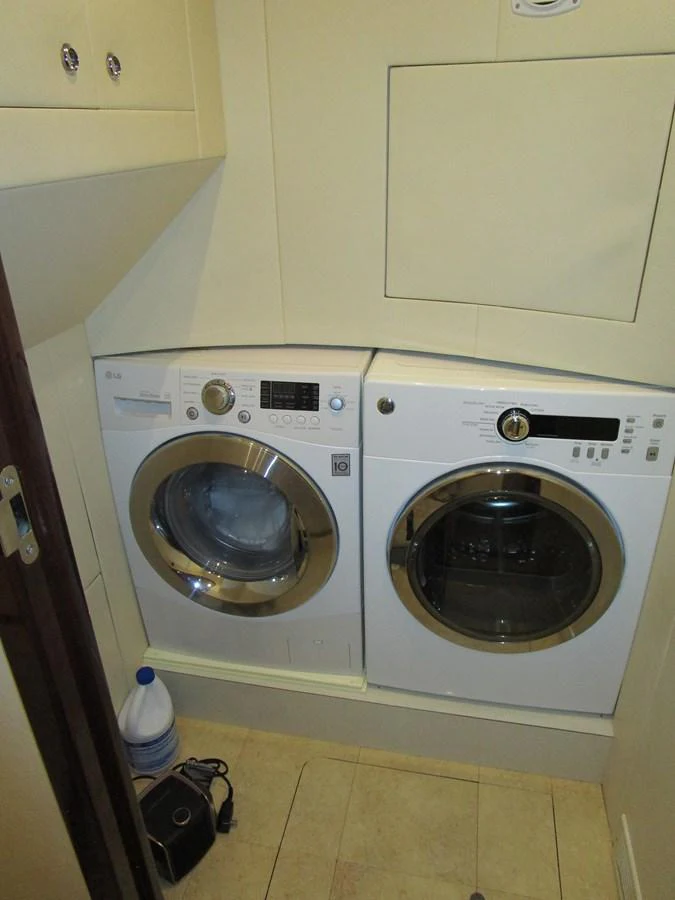 The yacht features a well-equipped laundry room with modern appliances. aboard SHORE GIRL Yacht for Sale