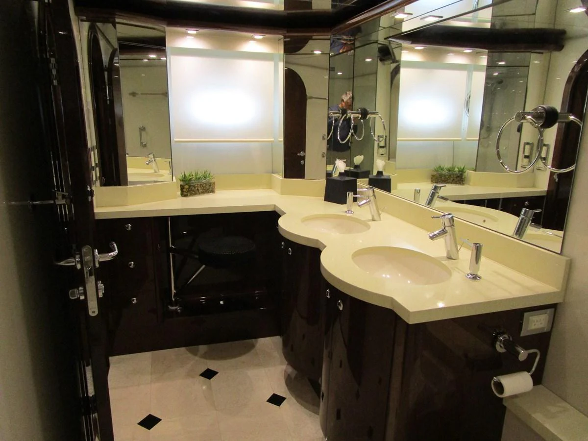 The yacht's bathroom features elegant fixtures and a sophisticated design with ample counter space. aboard SHORE GIRL Yacht for Sale