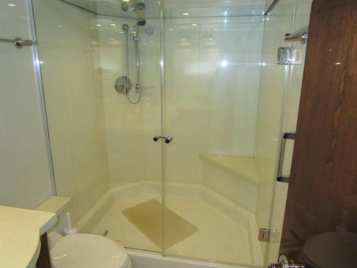 The yacht's bathroom features a modern glass-enclosed shower with sleek fixtures. aboard SHORE GIRL Yacht for Sale