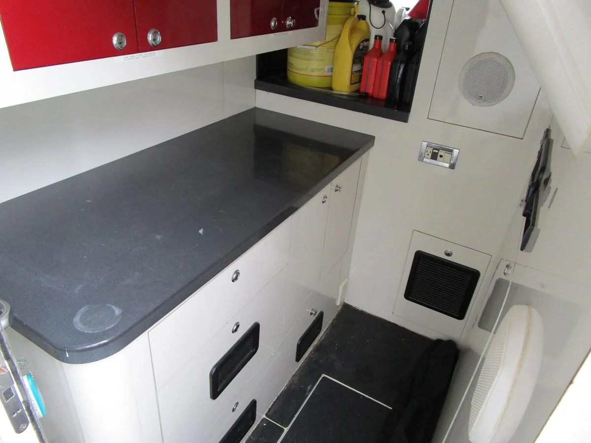 This image showcases a functional interior workspace on the yacht, featuring storage cabinets and a countertop. aboard SHORE GIRL Yacht for Sale