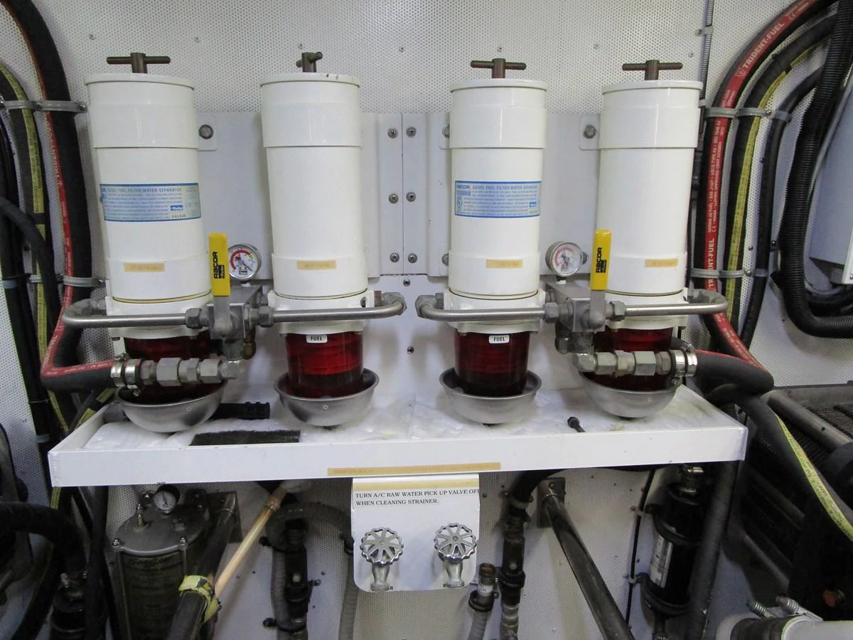 The image shows a detailed view of the yacht's engine room with fuel filters and associated piping. aboard SHORE GIRL Yacht for Sale