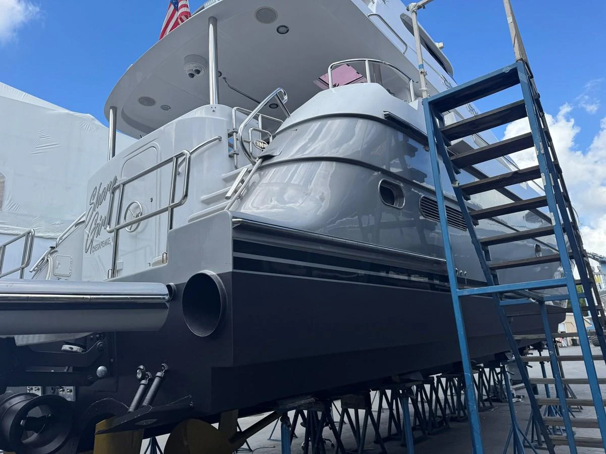 The yacht is seen out of the water, showcasing its sleek hull and multiple decks. aboard SHORE GIRL Yacht for Sale