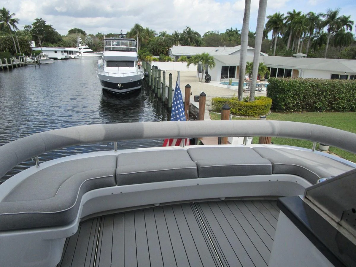 The aft deck features comfortable seating with a scenic view of the marina. aboard SHORE GIRL Yacht for Sale