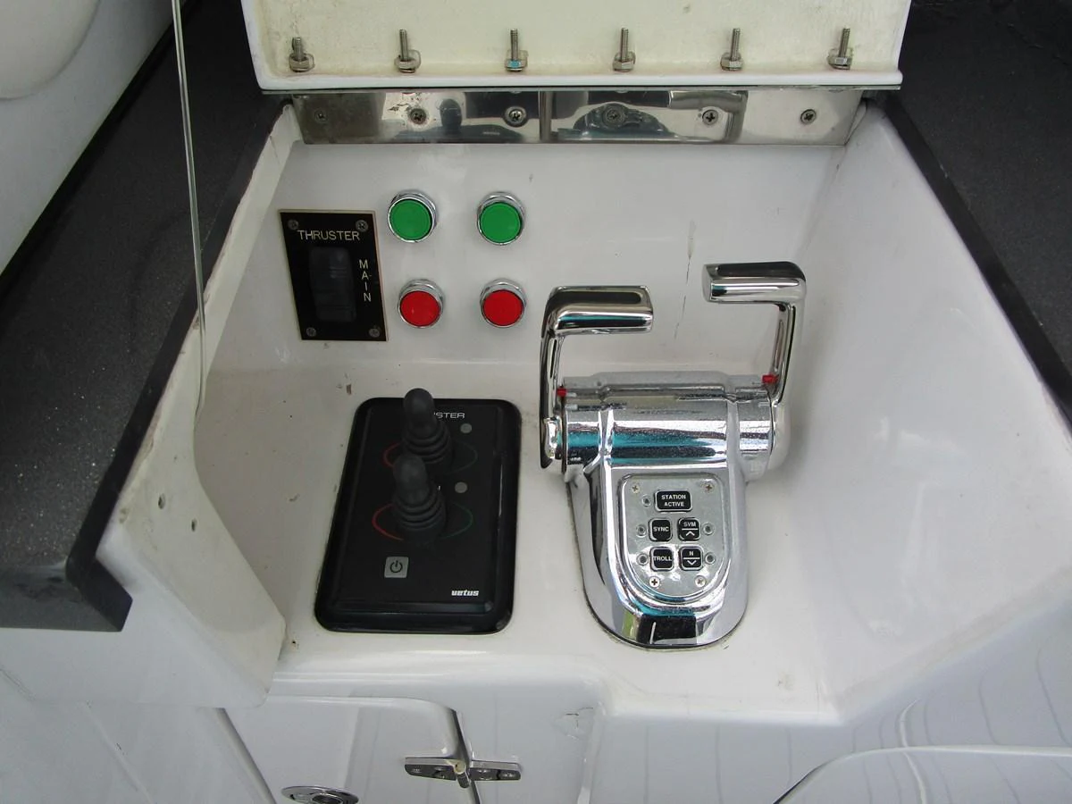 The image showcases the control panel and throttle of the yacht, highlighting its advanced navigation equipment. aboard SHORE GIRL Yacht for Sale