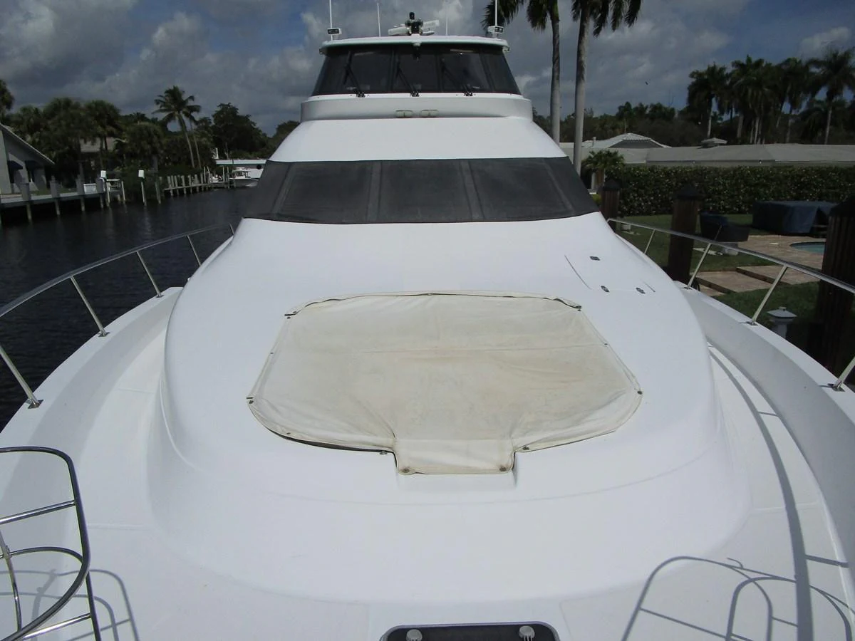 The yacht's sleek exterior showcases a spacious foredeck with a sunpad area. aboard SHORE GIRL Yacht for Sale