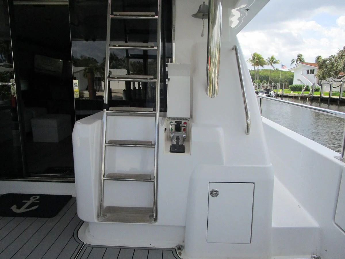 The image showcases a detailed view of the yacht's exterior with a ladder and control panel. aboard SHORE GIRL Yacht for Sale