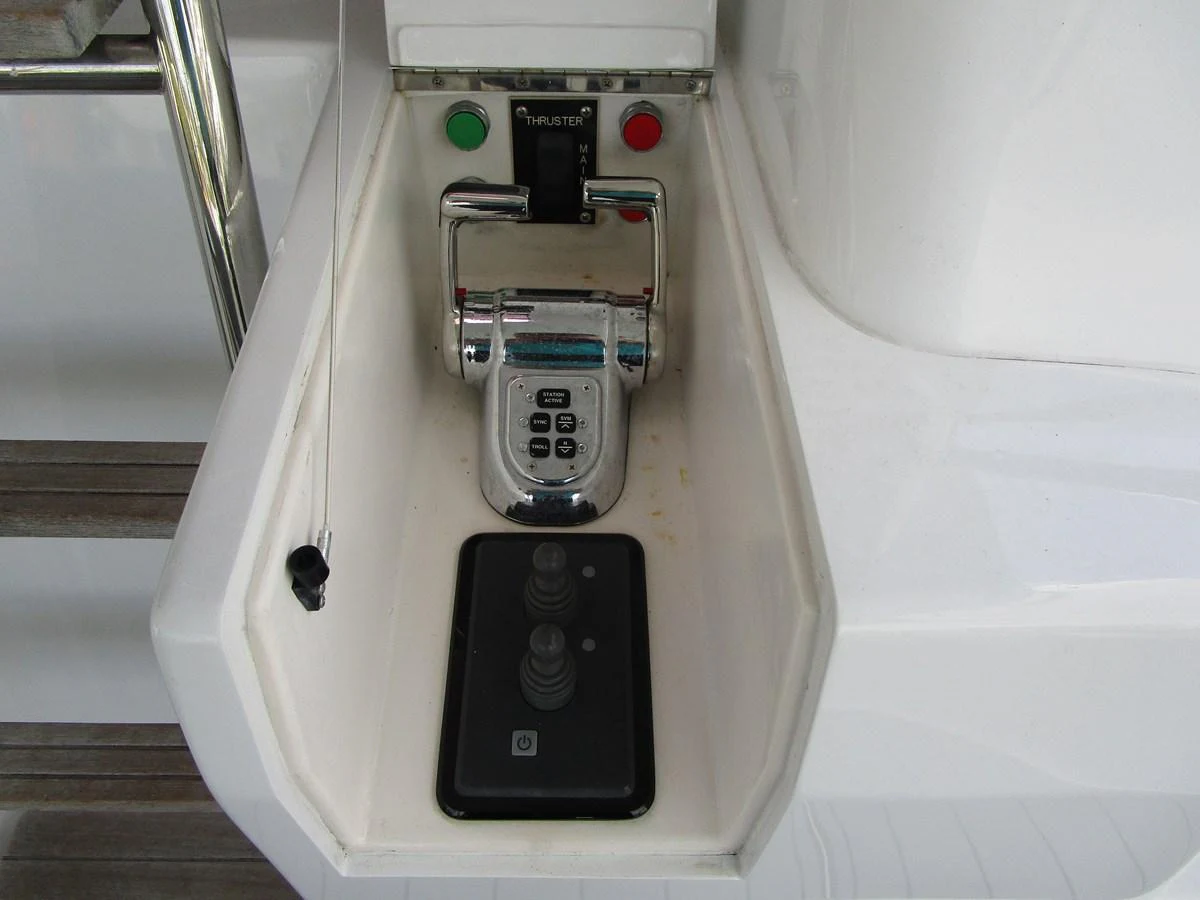 A close-up view of the yacht's control panel featuring throttle and joystick controls. aboard SHORE GIRL Yacht for Sale