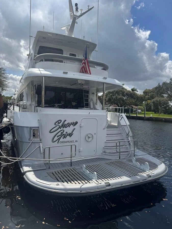 The yacht's aft deck features a spacious swim platform and elegant design details. aboard SHORE GIRL Yacht for Sale