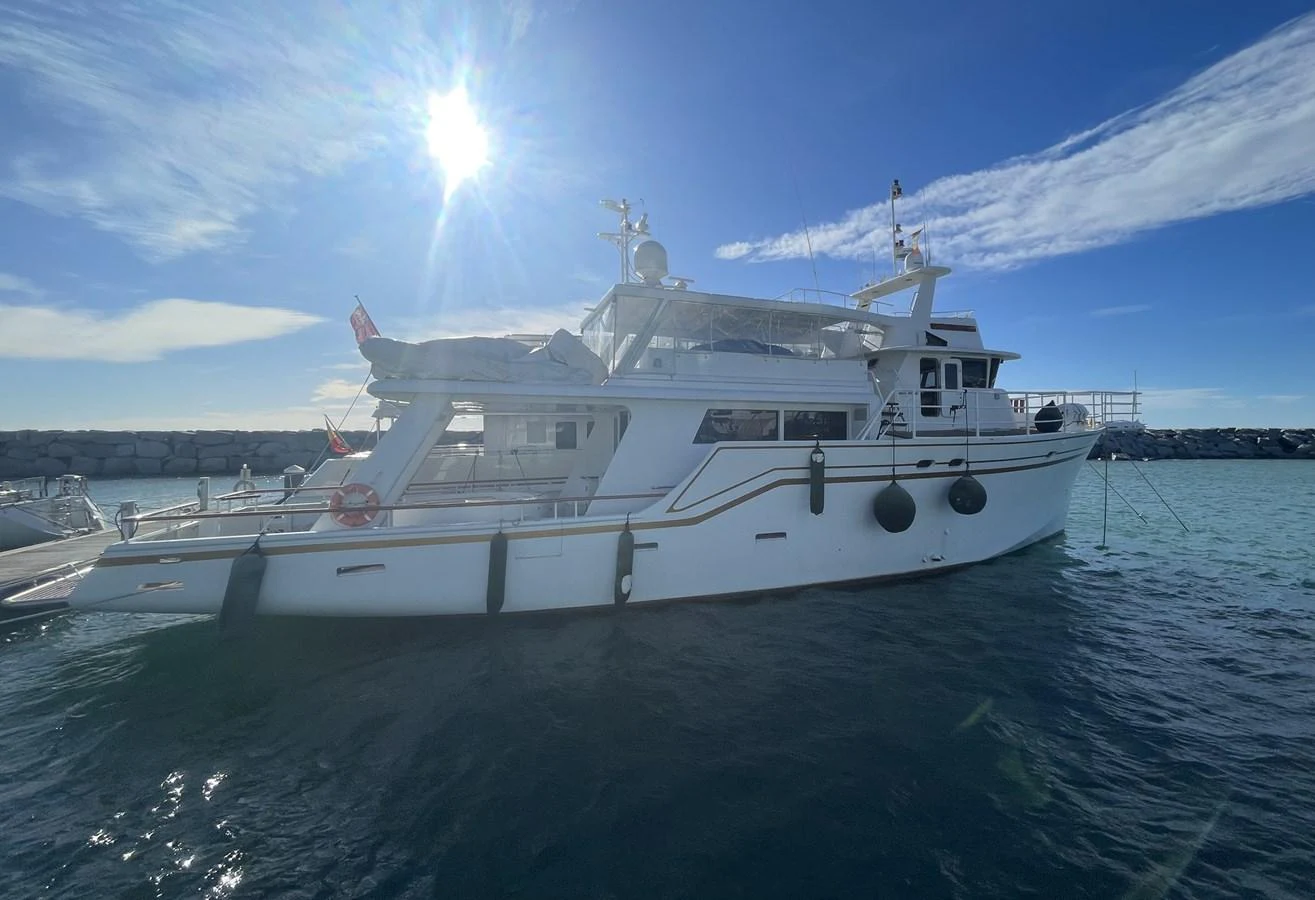 A sleek yacht is anchored in calm waters under a bright, sunny sky. aboard ATB MAROC  CUSTOM MOTOR YACHT Yacht for Sale