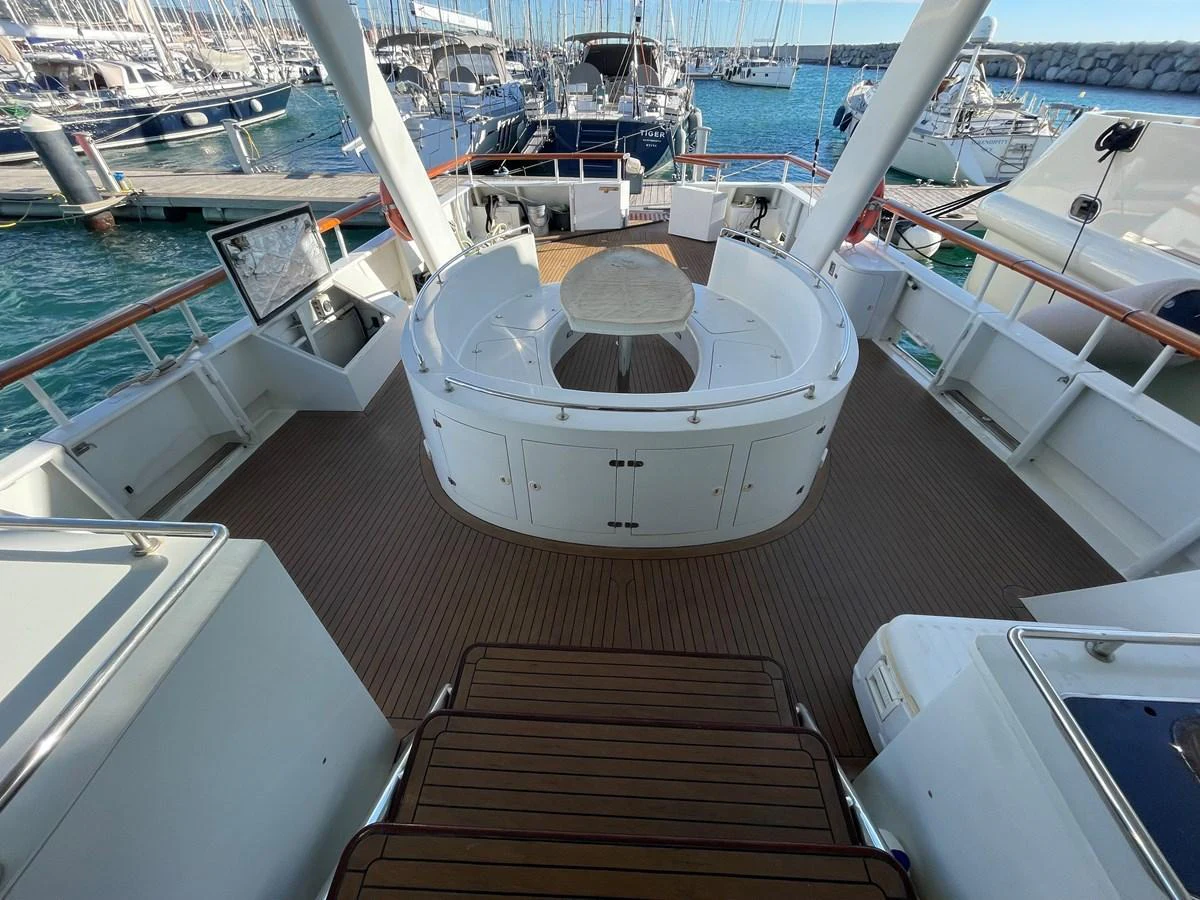 The aft deck features a spacious seating area with a central table, perfect for outdoor gatherings. aboard ATB MAROC  CUSTOM MOTOR YACHT Yacht for Sale