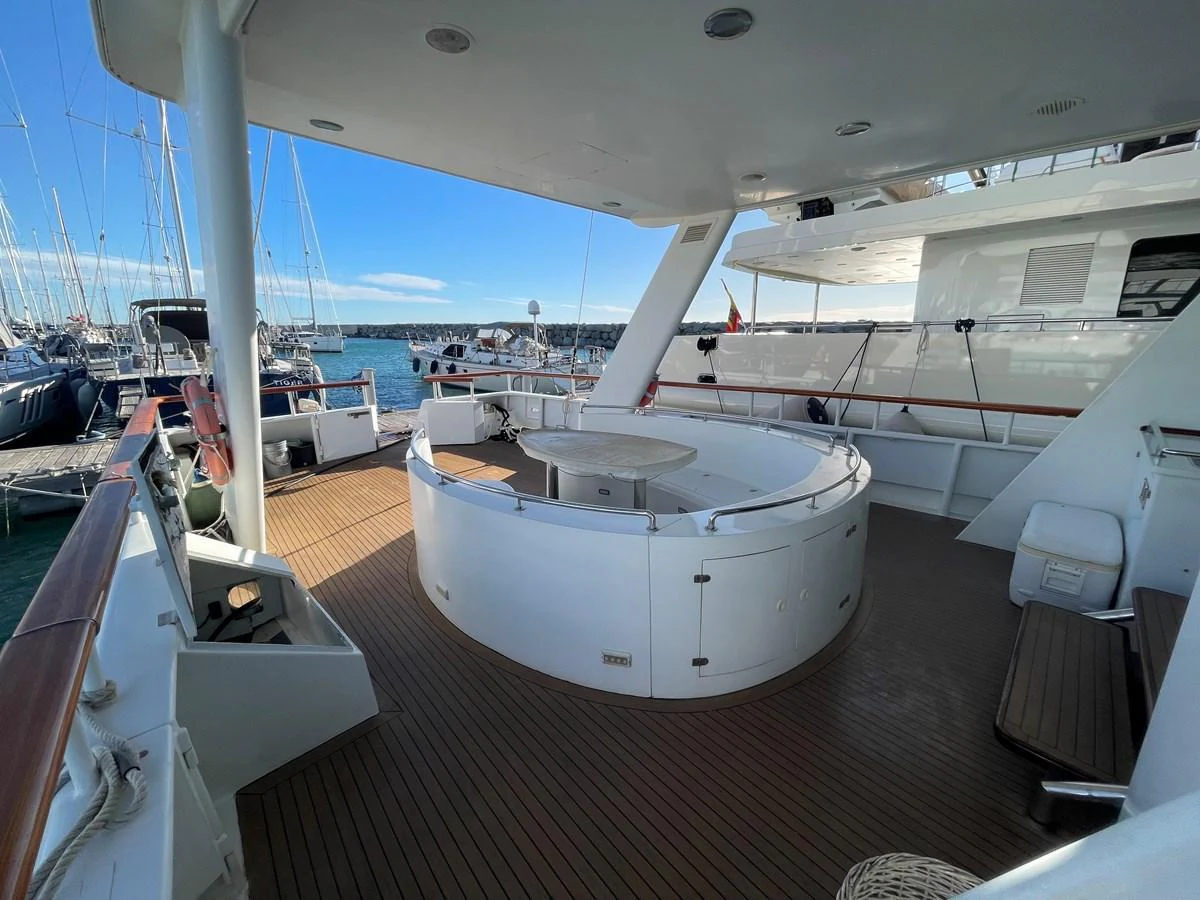 The aft deck features a spacious seating area with a round table, perfect for outdoor relaxation and dining. aboard ATB MAROC  CUSTOM MOTOR YACHT Yacht for Sale