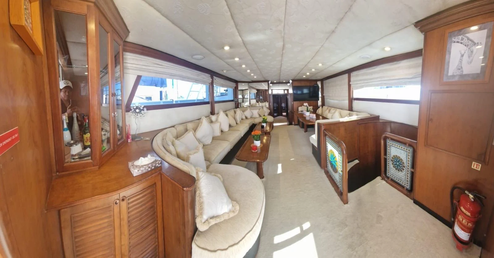 The spacious salon features plush seating and elegant wooden cabinetry, creating a warm and inviting atmosphere. aboard ATB MAROC  CUSTOM MOTOR YACHT Yacht for Sale