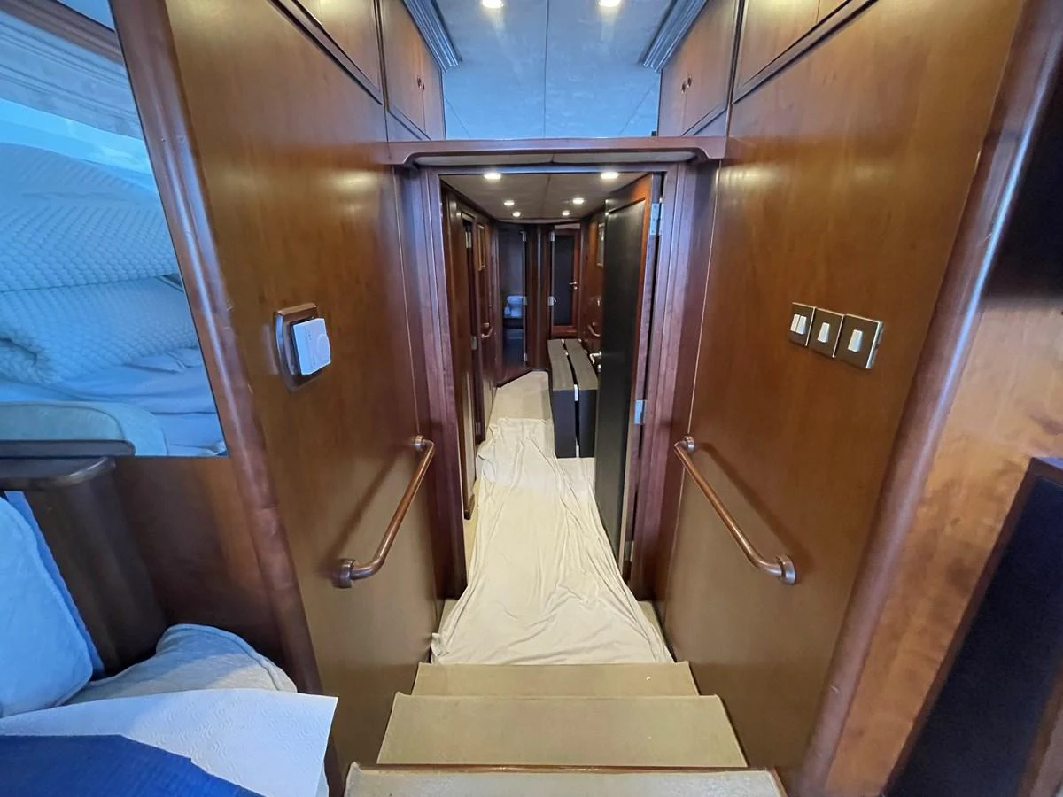 A luxurious hallway with rich wood paneling and soft lighting leads to the yacht's interior cabins. aboard ATB MAROC  CUSTOM MOTOR YACHT Yacht for Sale