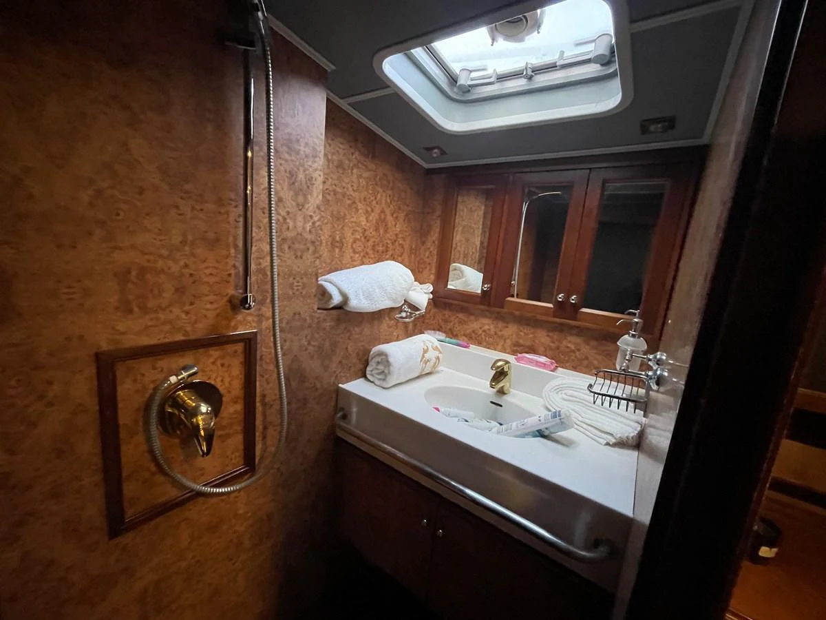 The yacht's bathroom features a sleek design with a skylight, providing a touch of natural light. aboard ATB MAROC  CUSTOM MOTOR YACHT Yacht for Sale