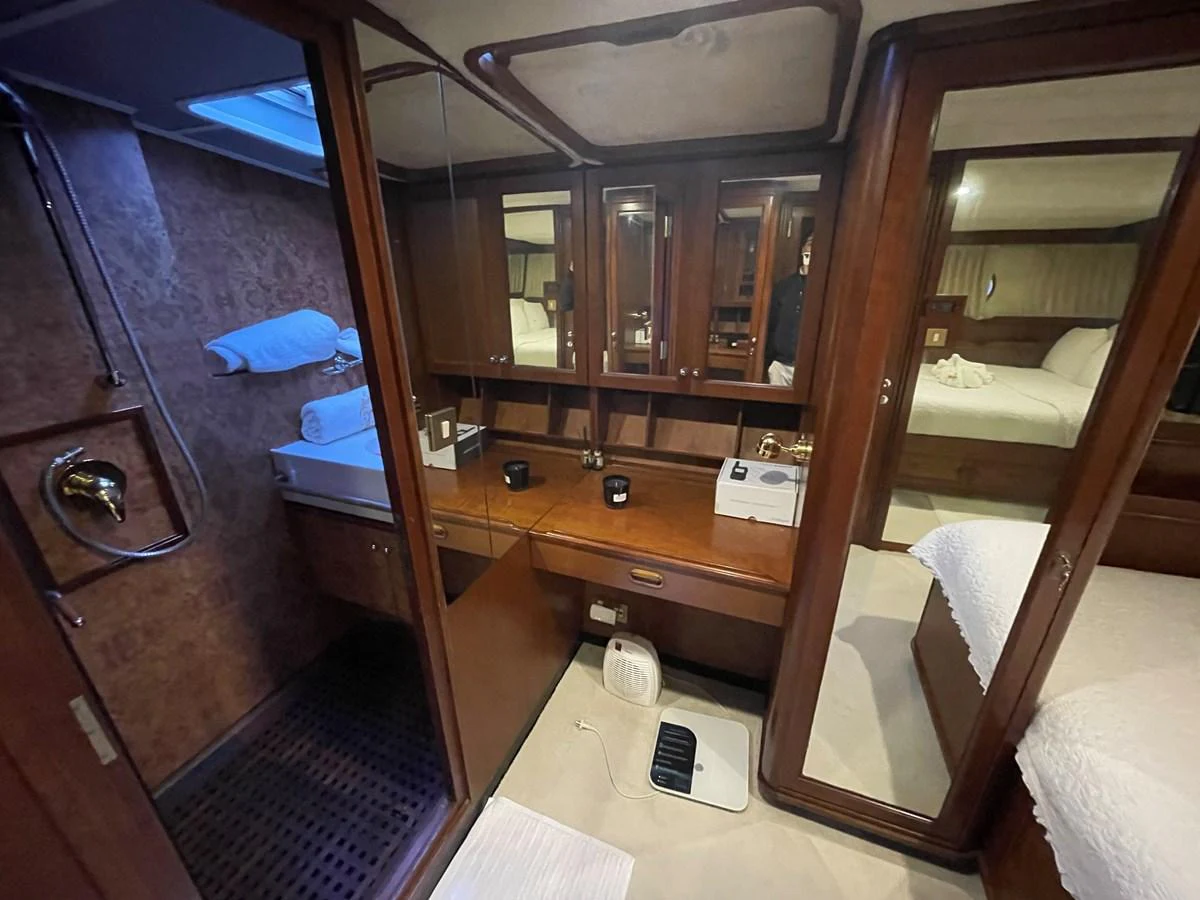 The image showcases a luxurious stateroom with a vanity area and an en-suite bathroom. aboard ATB MAROC  CUSTOM MOTOR YACHT Yacht for Sale