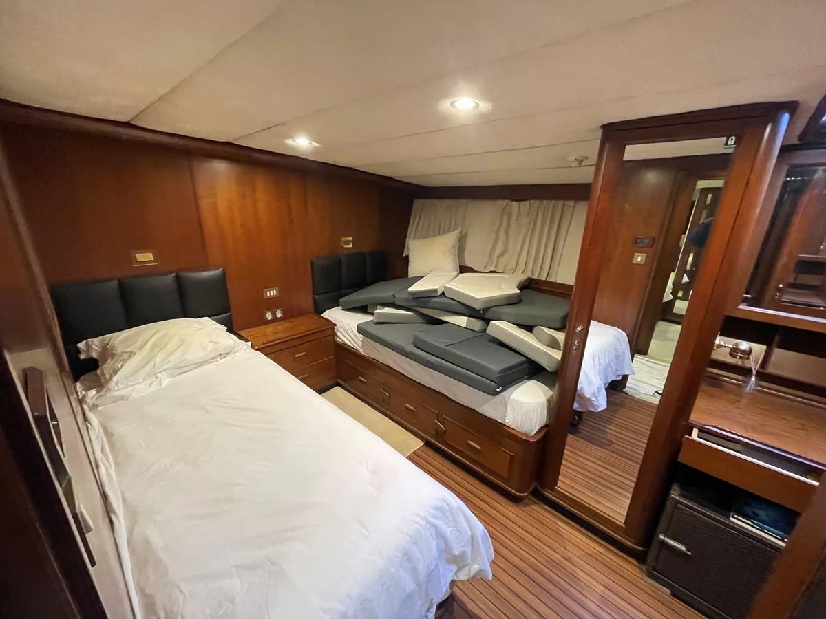 A cozy guest stateroom featuring twin beds and warm wood paneling. aboard ATB MAROC  CUSTOM MOTOR YACHT Yacht for Sale