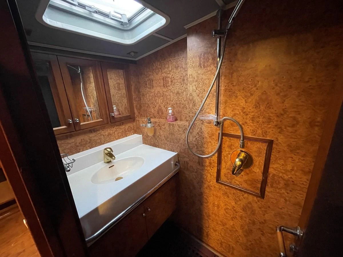 A well-appointed yacht bathroom with a sleek sink and wooden cabinetry. aboard ATB MAROC  CUSTOM MOTOR YACHT Yacht for Sale