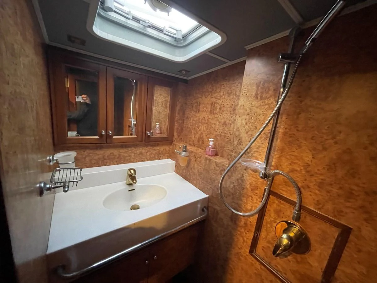 The yacht's bathroom features a sleek sink, a mirror, and a shower with a luxurious finish. aboard ATB MAROC  CUSTOM MOTOR YACHT Yacht for Sale