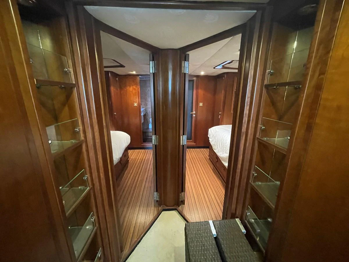 A cozy stateroom hallway with wooden finishes and two bedrooms visible. aboard ATB MAROC  CUSTOM MOTOR YACHT Yacht for Sale