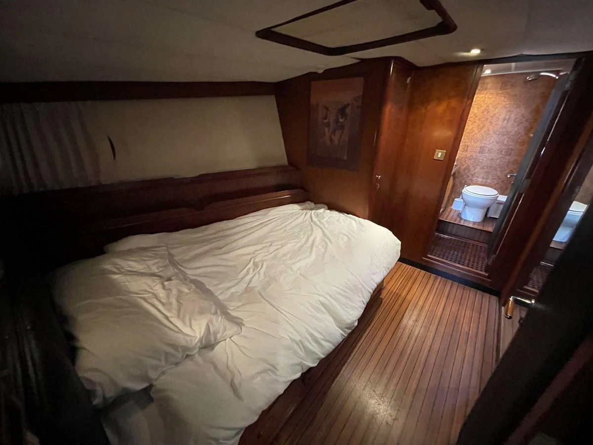 A cozy stateroom featuring a comfortable bed and an ensuite bathroom. aboard ATB MAROC  CUSTOM MOTOR YACHT Yacht for Sale