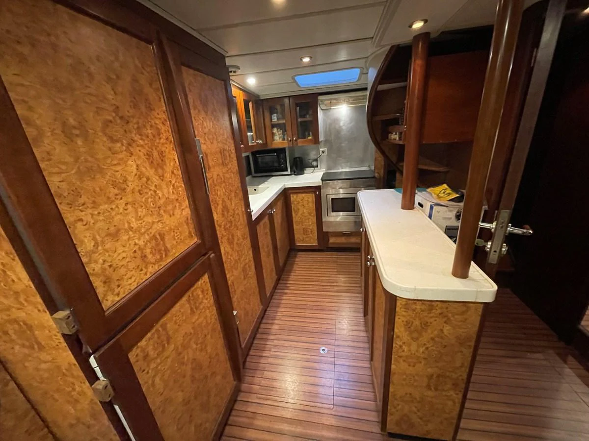 The yacht's galley features warm wood finishes and modern appliances, creating a cozy and functional space for meal preparation. aboard ATB MAROC  CUSTOM MOTOR YACHT Yacht for Sale