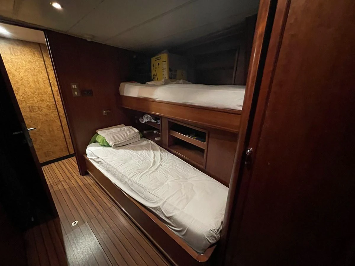 The image shows a cozy crew quarters with bunk beds and wooden finishes. aboard ATB MAROC  CUSTOM MOTOR YACHT Yacht for Sale