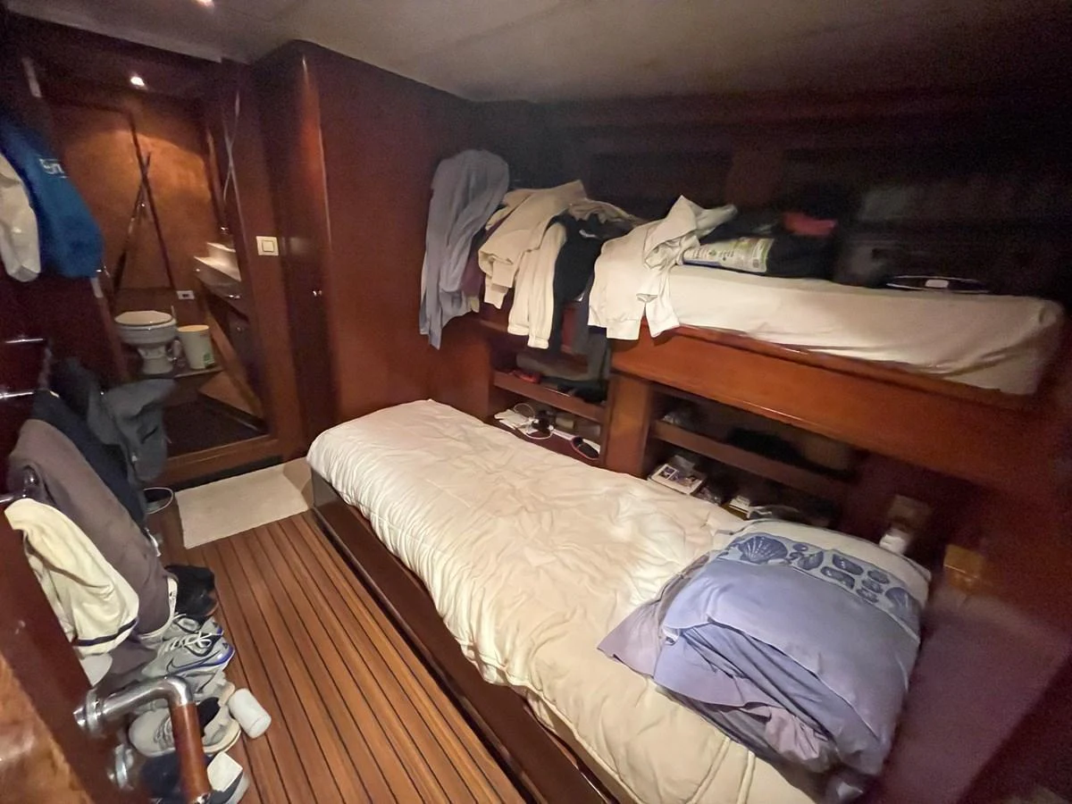 A cozy stateroom with bunk beds and warm wooden accents. aboard ATB MAROC  CUSTOM MOTOR YACHT Yacht for Sale