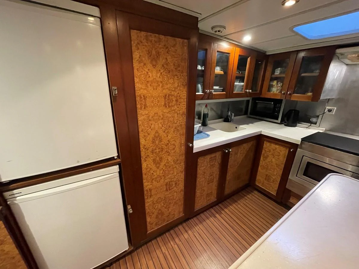 The galley features wood cabinetry, modern appliances, and ample counter space. aboard ATB MAROC  CUSTOM MOTOR YACHT Yacht for Sale