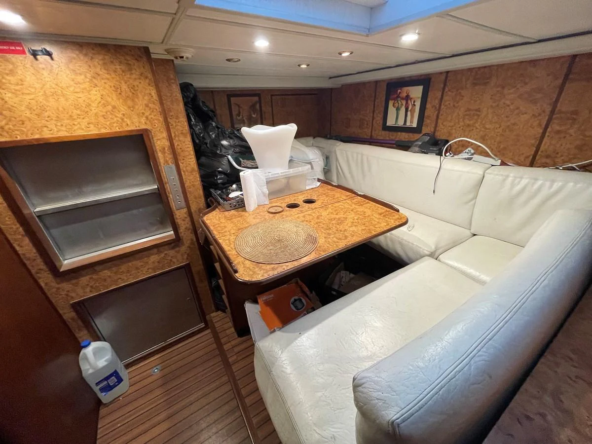 The yacht's cozy dining area features a wooden table surrounded by comfortable seating. aboard ATB MAROC  CUSTOM MOTOR YACHT Yacht for Sale