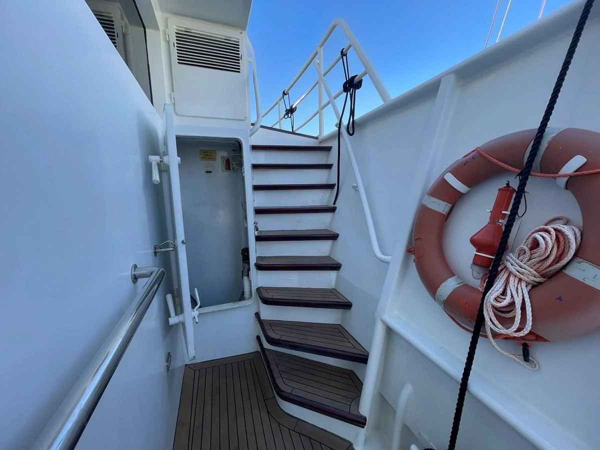 A close-up view of the yacht's exterior staircase and safety equipment. aboard ATB MAROC  CUSTOM MOTOR YACHT Yacht for Sale