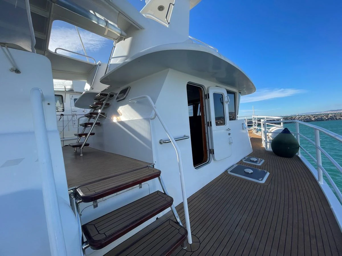 The aft deck features a sleek design with wooden steps and a spacious walkway. aboard ATB MAROC  CUSTOM MOTOR YACHT Yacht for Sale