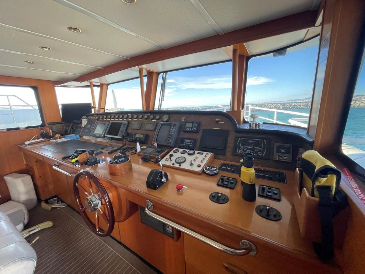 The helm station features an array of navigation equipment and controls, offering a commanding view of the sea. aboard ATB MAROC  CUSTOM MOTOR YACHT Yacht for Sale