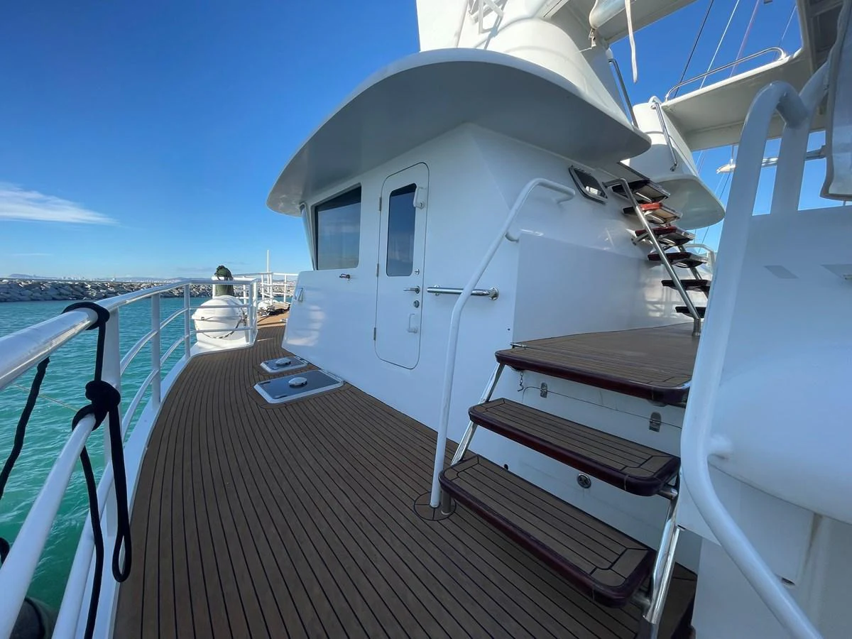 The yacht's exterior features a sleek design with wooden deck flooring and modern railings. aboard ATB MAROC  CUSTOM MOTOR YACHT Yacht for Sale
