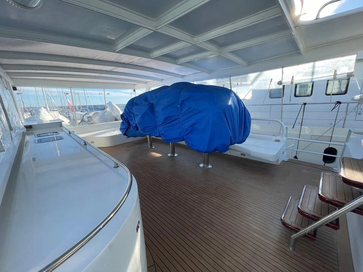 The aft deck features a spacious area with a covered tender and ample seating. aboard ATB MAROC  CUSTOM MOTOR YACHT Yacht for Sale