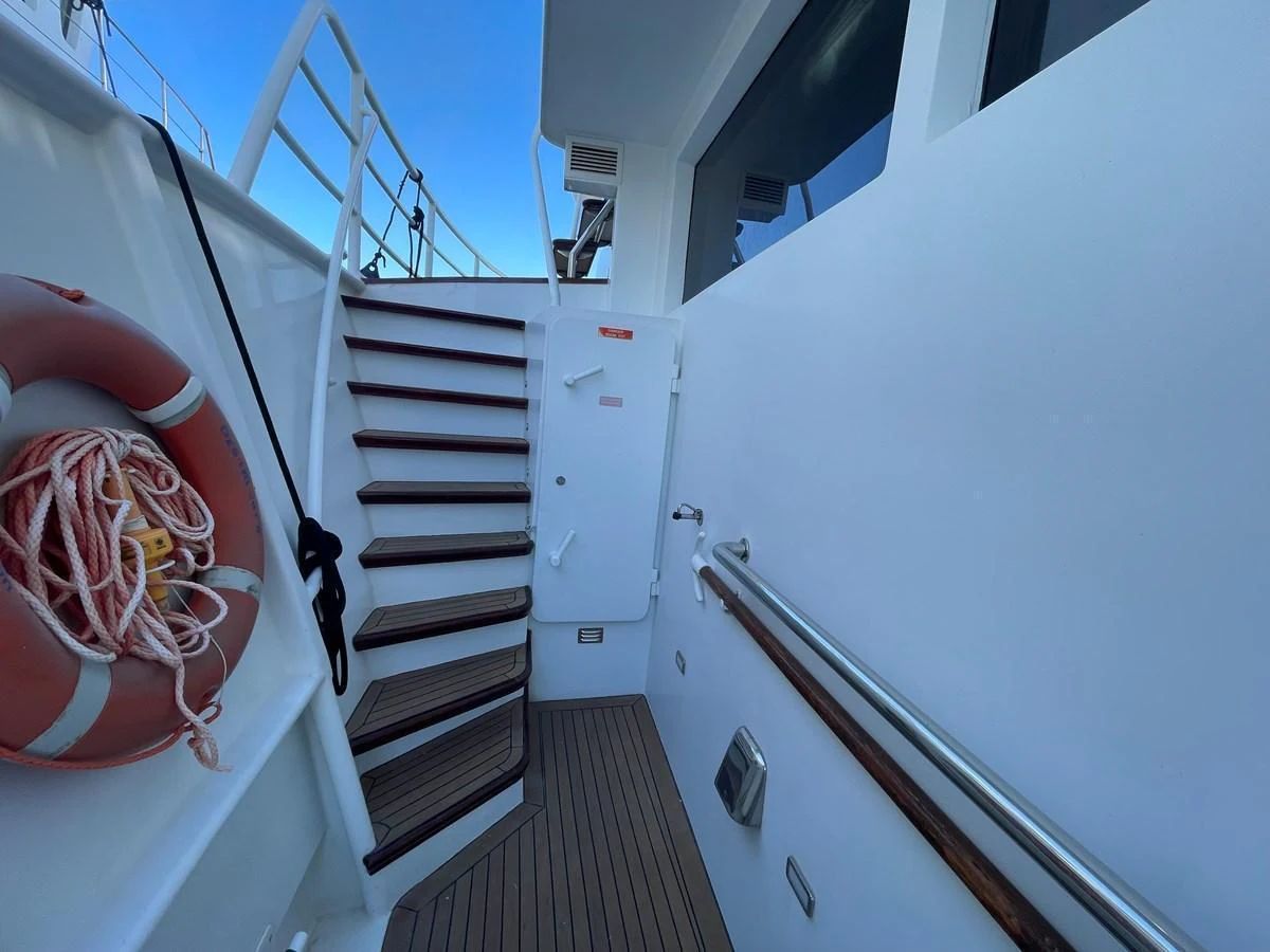 The image showcases a stairway on the exterior of the yacht, leading to an upper deck. aboard ATB MAROC  CUSTOM MOTOR YACHT Yacht for Sale