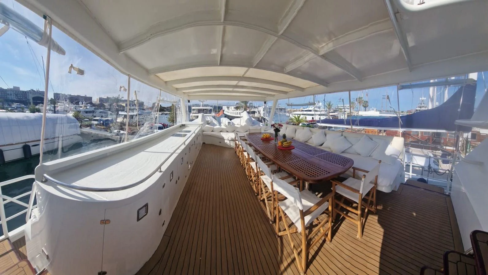 The aft deck features a spacious dining area with comfortable seating and a large table. aboard ATB MAROC  CUSTOM MOTOR YACHT Yacht for Sale