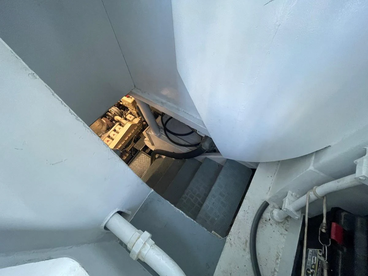 A view of the yacht's engine room showcasing mechanical components and access stairs. aboard ATB MAROC  CUSTOM MOTOR YACHT Yacht for Sale