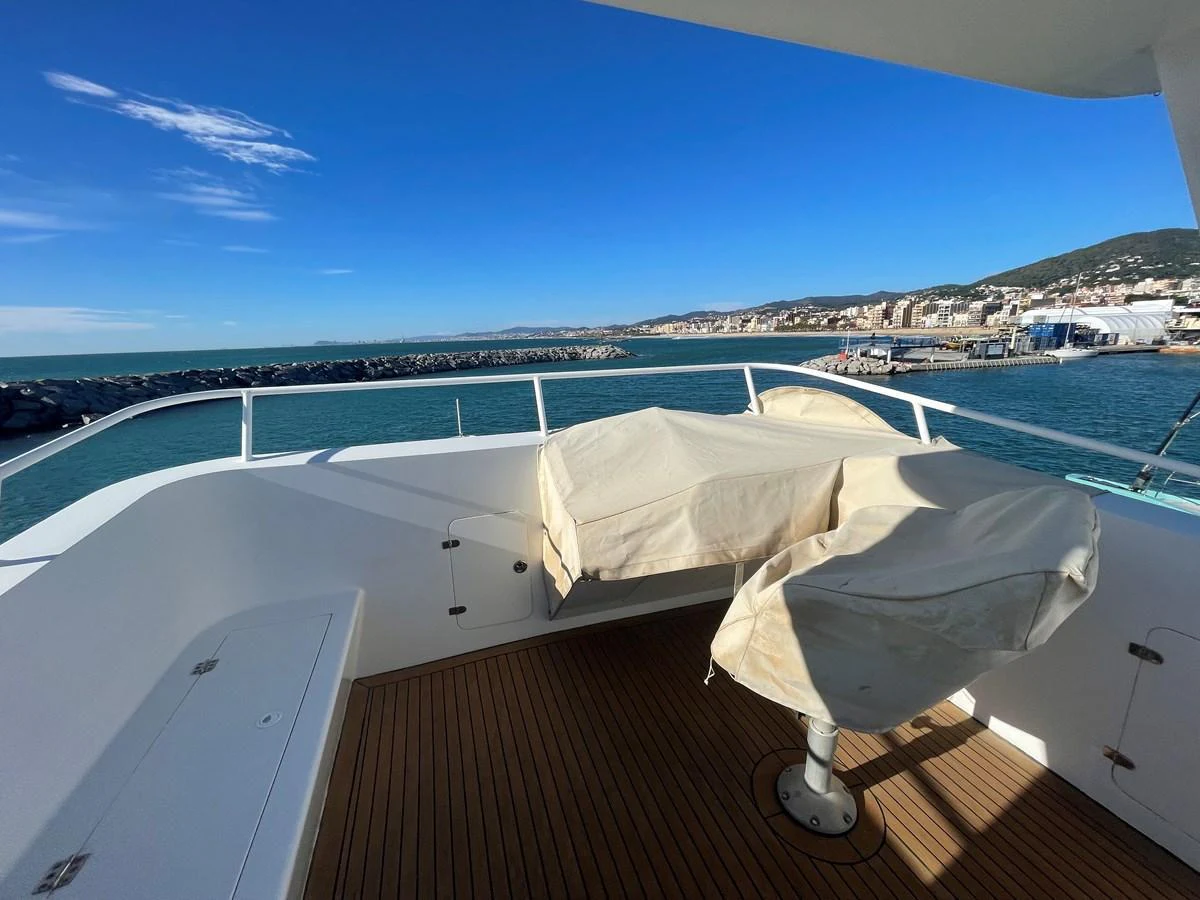 The yacht's aft deck offers a serene view of the coastline with covered seating arrangements. aboard ATB MAROC  CUSTOM MOTOR YACHT Yacht for Sale
