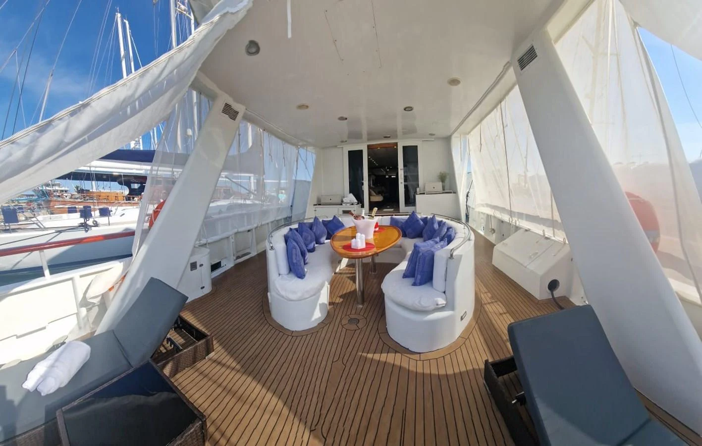 The aft deck features a cozy seating area with a round table, perfect for relaxation and socializing. aboard ATB MAROC  CUSTOM MOTOR YACHT Yacht for Sale