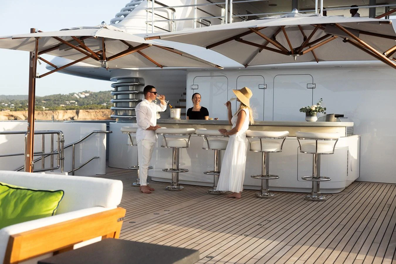 a man and woman standing in a room with a table and chairs aboard ROCINANTE Yacht for Sale