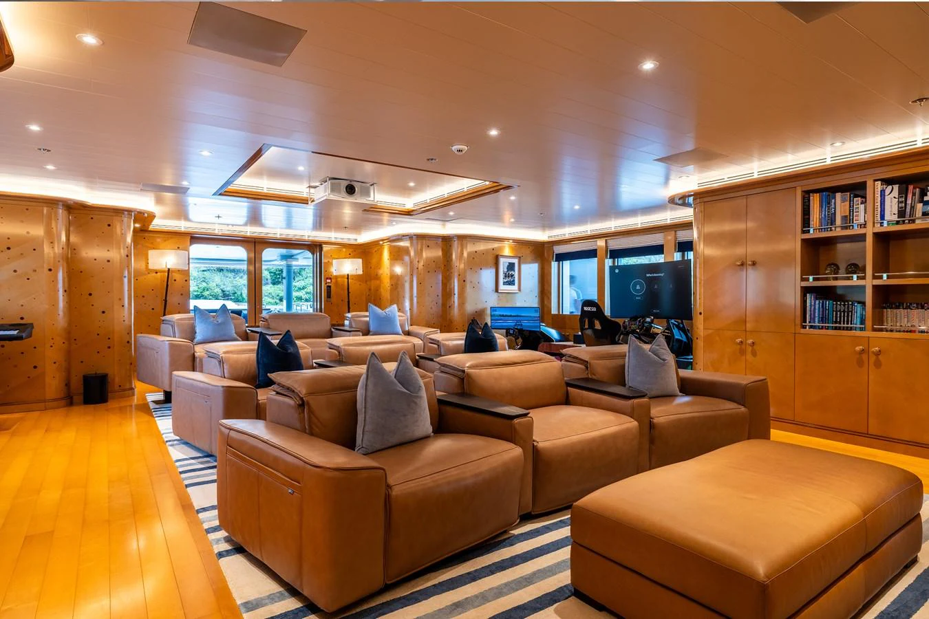 a living room with a large wood cabinet and a large tv aboard ROCINANTE Yacht for Sale