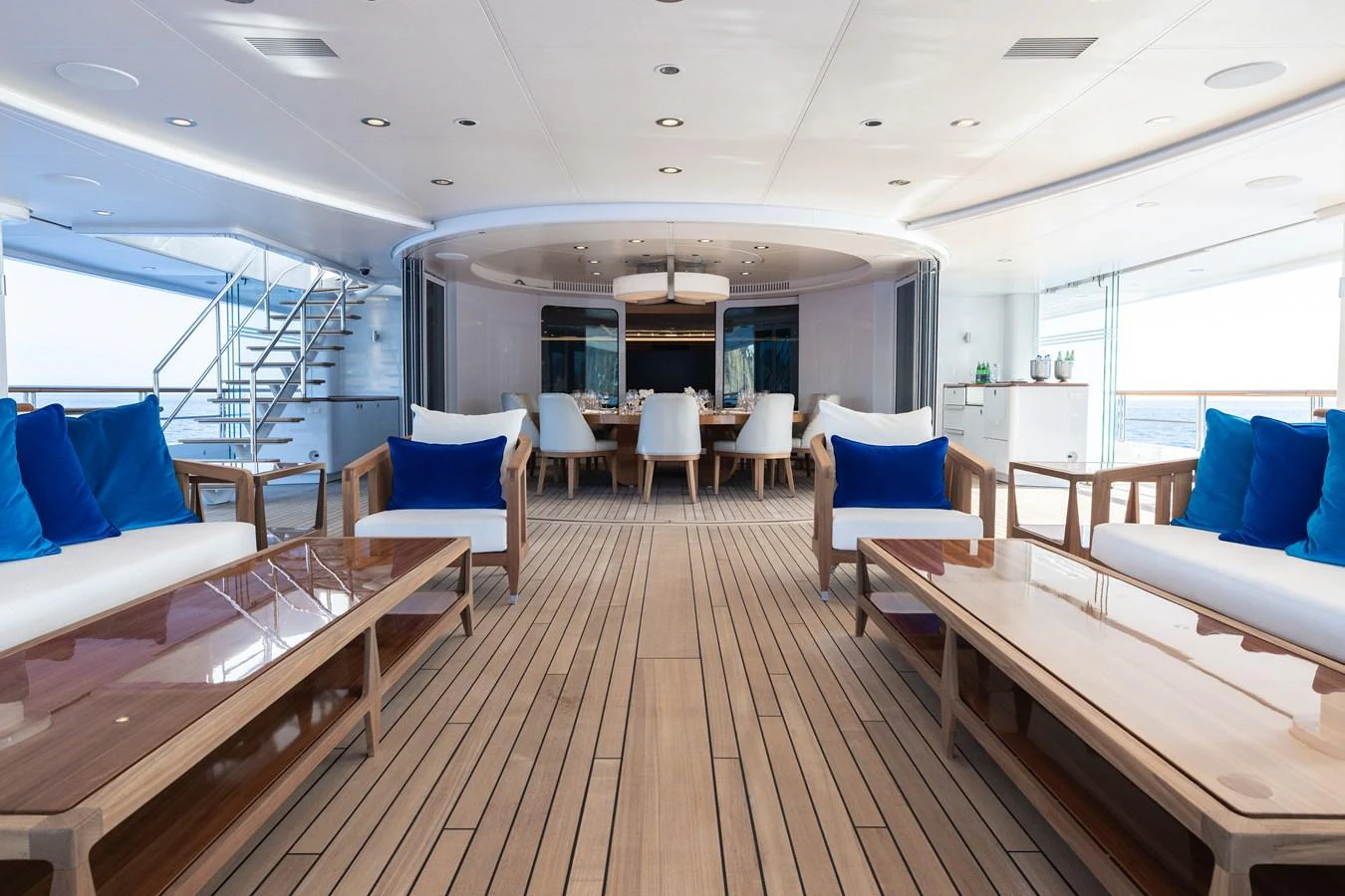 a large room with a wood floor and white chairs and a wood floor aboard ROCINANTE Yacht for Sale