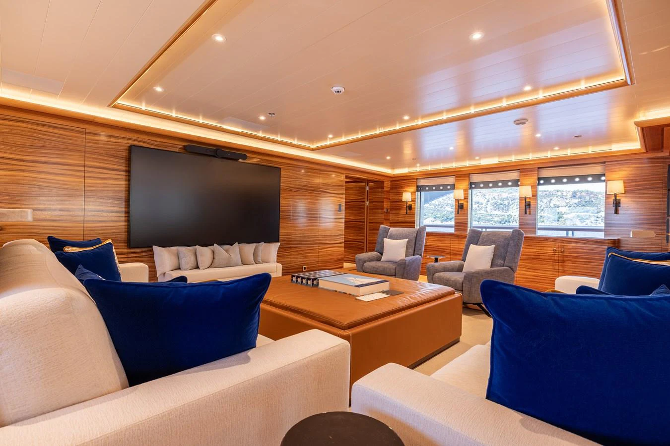 a room with a tv and couches aboard ROCINANTE Yacht for Sale