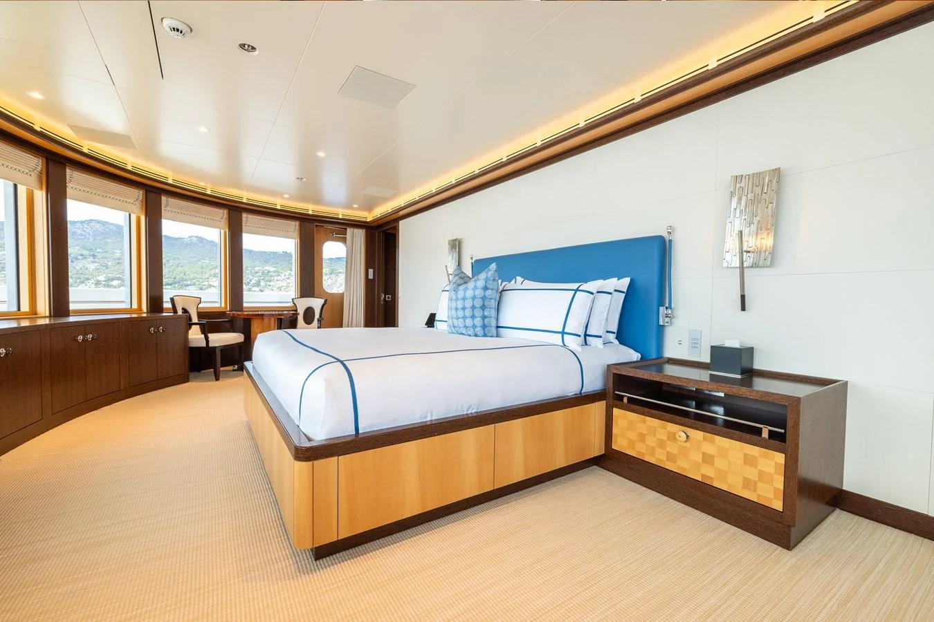 a bedroom with a bed and a desk aboard ROCINANTE Yacht for Sale